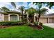 Well-manicured front yard with lush green lawn and tropical landscaping enhances curb appeal at 10532 Plantation Bay Dr, Tampa, FL 33647
