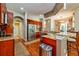 A stylish kitchen featuring granite countertops, stainless steel appliances, and cherry wood cabinetry at 10532 Plantation Bay Dr, Tampa, FL 33647