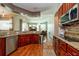 A stylish kitchen featuring granite countertops, stainless steel appliances, and cherry wood cabinetry at 10532 Plantation Bay Dr, Tampa, FL 33647
