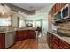 Kitchen with stainless appliances, granite countertops, wood cabinets, and easy access to living spaces at 10532 Plantation Bay Dr, Tampa, FL 33647