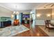 Bright living room features hardwood floors, a mini bar, wainscotting, and a decorative chandelier at 10532 Plantation Bay Dr, Tampa, FL 33647