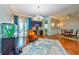 Well-lit living room showcasing an eclectic chair, stylish rug, bar and hardwood floors, ideal for gathering at 10532 Plantation Bay Dr, Tampa, FL 33647
