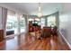 Bright living room with hardwood floors, large windows, and sliding doors to outdoor pool area at 10532 Plantation Bay Dr, Tampa, FL 33647