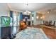 Spacious living room with hardwood floors, wet bar, decorative rug, and a dining table with four chairs at 10532 Plantation Bay Dr, Tampa, FL 33647