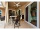Covered patio with ceiling fan, table, chairs, beverage cooler, and sliding glass doors to interior at 10532 Plantation Bay Dr, Tampa, FL 33647