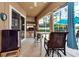 Covered patio with ceiling fan, table, chairs, beverage cooler, and a built-in outdoor kitchen at 10532 Plantation Bay Dr, Tampa, FL 33647