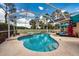 Screened-in pool and spa, perfect for relaxation and entertainment with a white fence and lake view at 10532 Plantation Bay Dr, Tampa, FL 33647