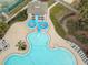 Aerial image shows a zero-entry pool with a water slide and lounge chairs at 10532 Plantation Bay Dr, Tampa, FL 33647