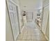 Clean and bright bathroom featuring a glass-enclosed shower, bathtub, neutral finishes, and double doors at 10924 Summerton Dr, Riverview, FL 33579