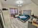 Bedroom with an ornate headboard bed frame, hardwood floors, and plenty of room to put a crib at 10924 Summerton Dr, Riverview, FL 33579