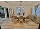 Formal dining room features hardwood floors, an elegant light fixture, and beige colored furniture at 10924 Summerton Dr, Riverview, FL 33579