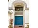 Inviting blue double front doors with a large window above, framed by light stucco walls at 10924 Summerton Dr, Riverview, FL 33579