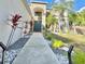 Home's front yard has manicured landscaping and unique accent plants along the walkway at 10924 Summerton Dr, Riverview, FL 33579