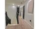 Hallway showcasing modern interior doors, neutral carpet, and artistic wall decor, connecting the living spaces at 10924 Summerton Dr, Riverview, FL 33579
