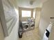 Bright laundry room with stainless steel washer and dryer and tile flooring at 10924 Summerton Dr, Riverview, FL 33579