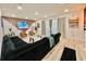 Bright living room featuring a large sectional sofa, stylish decor, and sliding glass doors to the outdoor space at 10924 Summerton Dr, Riverview, FL 33579