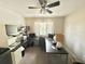 Functional home office featuring a ceiling fan, lots of desk space, and natural light from the window at 10924 Summerton Dr, Riverview, FL 33579