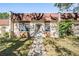 Charming townhome featuring a red tile roof, front yard, and walkway to the front door at 11511 113Th St # 22E, Largo, FL 33778