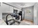 Bright kitchen features white cabinets, granite counters, and stainless steel appliances at 11511 113Th St # 22E, Largo, FL 33778