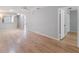 Living area with wood-look floors, neutral walls, and an open doorway to another room at 11511 113Th St # 22E, Largo, FL 33778