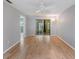 Bright living room featuring modern floors, a ceiling fan, and sliding glass doors to the outdoors at 11511 113Th St # 22E, Largo, FL 33778
