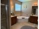 A well-lit bathroom featuring a bathtub and shower at 12231 Fairlawn Dr, Riverview, FL 33579
