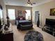 A serene main bedroom featuring a comfortable bed, soft lighting, and neutral decor at 12231 Fairlawn Dr, Riverview, FL 33579