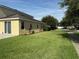 Well-manicured lawn with lush green grass and landscape beds with flowering plants, enhances curb appeal at 12231 Fairlawn Dr, Riverview, FL 33579