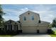 Charming two-story home with a two-car garage, manicured lawn, and classic architectural details at 12231 Fairlawn Dr, Riverview, FL 33579