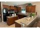 Modern kitchen with granite countertops, ample cabinetry, and stainless steel appliances at 12231 Fairlawn Dr, Riverview, FL 33579