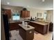 Spacious kitchen features granite countertops, dark wood cabinets, and stainless steel appliances at 12231 Fairlawn Dr, Riverview, FL 33579