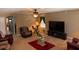 Spacious living room boasts carpet, ceiling fan, exercise equipment, and cozy furniture for relaxation and entertainment at 12231 Fairlawn Dr, Riverview, FL 33579