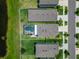 Overhead view of residences with fenced yards, manicured lawns and a pool in one of the backyards at 12826 French Market Dr, Riverview, FL 33579