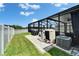 Enjoy the outdoors with a barbecue, patio, and screened-in pool in this backyard at 12826 French Market Dr, Riverview, FL 33579