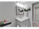 Bathroom featuring a single vanity, framed mirror, updated fixtures, and shelving at 12826 French Market Dr, Riverview, FL 33579