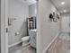 Powder room with a modern vanity, a decorative mirror, and a shelf with plants at 12826 French Market Dr, Riverview, FL 33579