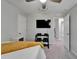 Bedroom featuring a mounted TV, workout equipment, and a comfortable bed, offering a multi-functional space at 12826 French Market Dr, Riverview, FL 33579
