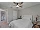 Bright bedroom featuring a ceiling fan, neutral walls, and stylish furnishings with natural lighting at 12826 French Market Dr, Riverview, FL 33579