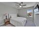 Bedroom with neutral decor features a ceiling fan, window, and side tables with lamps at 12826 French Market Dr, Riverview, FL 33579
