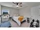 Cozy bedroom featuring a ceiling fan, a treadmill, weights, and a comfortable bed with simple decor at 12826 French Market Dr, Riverview, FL 33579