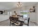 Dining area with sliding glass doors leading to a pool, offering indoor-outdoor flow and natural light at 12826 French Market Dr, Riverview, FL 33579
