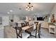 Dining room adjacent to the kitchen with a modern chandelier and an open concept leading to the living room at 12826 French Market Dr, Riverview, FL 33579
