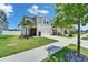 Charming two-story home with a well-manicured lawn, lush landscaping, and a welcoming facade at 12826 French Market Dr, Riverview, FL 33579