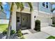 Inviting front entrance featuring a screened-in porch, landscaped walkway, and well-maintained exterior at 12826 French Market Dr, Riverview, FL 33579