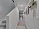 Bright hallway with gray vinyl floors leads to a sunny living area, enhanced by modern decor at 12826 French Market Dr, Riverview, FL 33579