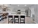 Spacious kitchen features a large island with seating, stainless steel appliances, and gray cabinets at 12826 French Market Dr, Riverview, FL 33579