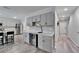 Kitchen with gray cabinets and a beverage cooler, with a view leading into an adjacent hallway at 12826 French Market Dr, Riverview, FL 33579