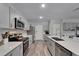 Bright, modern kitchen with stainless steel appliances, gray cabinetry, and a center island with seating at 12826 French Market Dr, Riverview, FL 33579