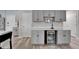 Features modern gray cabinets and a built-in beverage cooler for convenient entertaining at 12826 French Market Dr, Riverview, FL 33579
