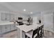 Modern kitchen with gray cabinets, stainless steel appliances, a central island and breakfast bar with seating at 12826 French Market Dr, Riverview, FL 33579